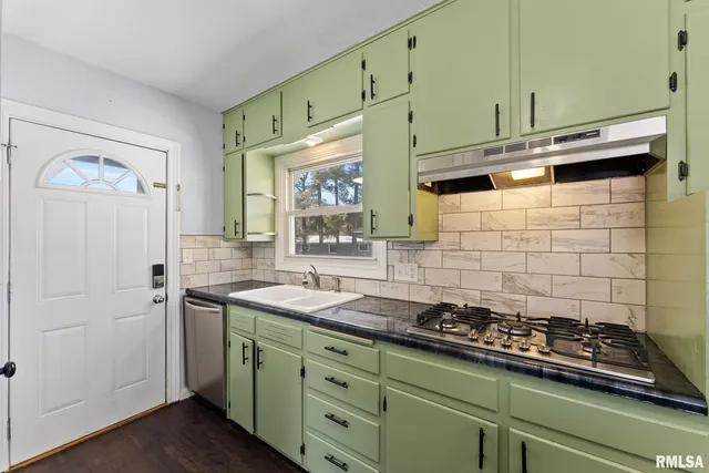 a kitchen with stainless steel appliances a stove and a refrigerator