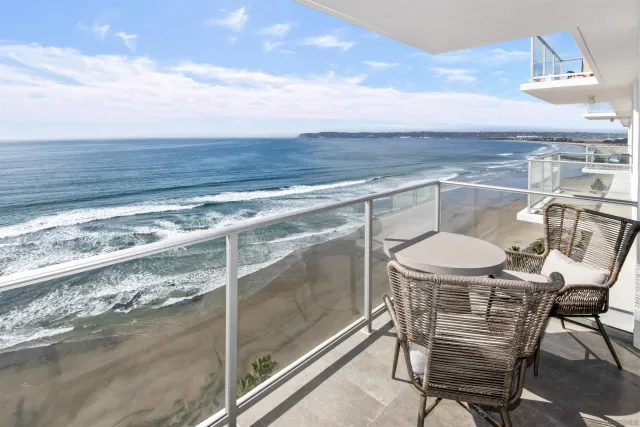 a balcony with table and chairs