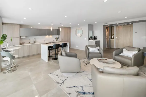 a living room with furniture and view of kitchen
