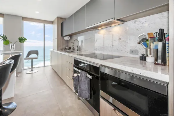 a kitchen with granite countertop a sink stove and cabinets