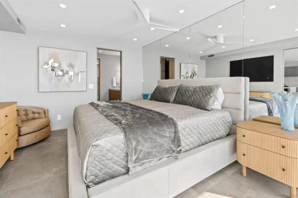 a bedroom with a bed and a flat screen tv