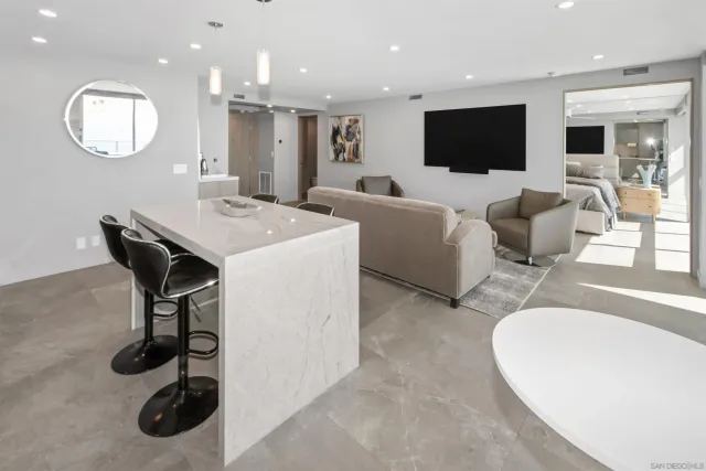 a living room with furniture a flat screen tv and a large window