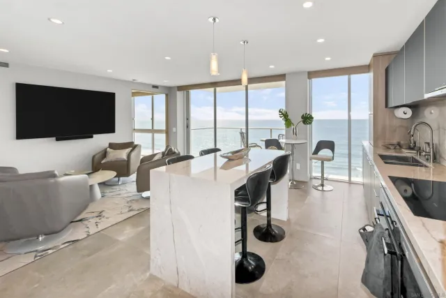 a living room with furniture a flat screen tv and a large window