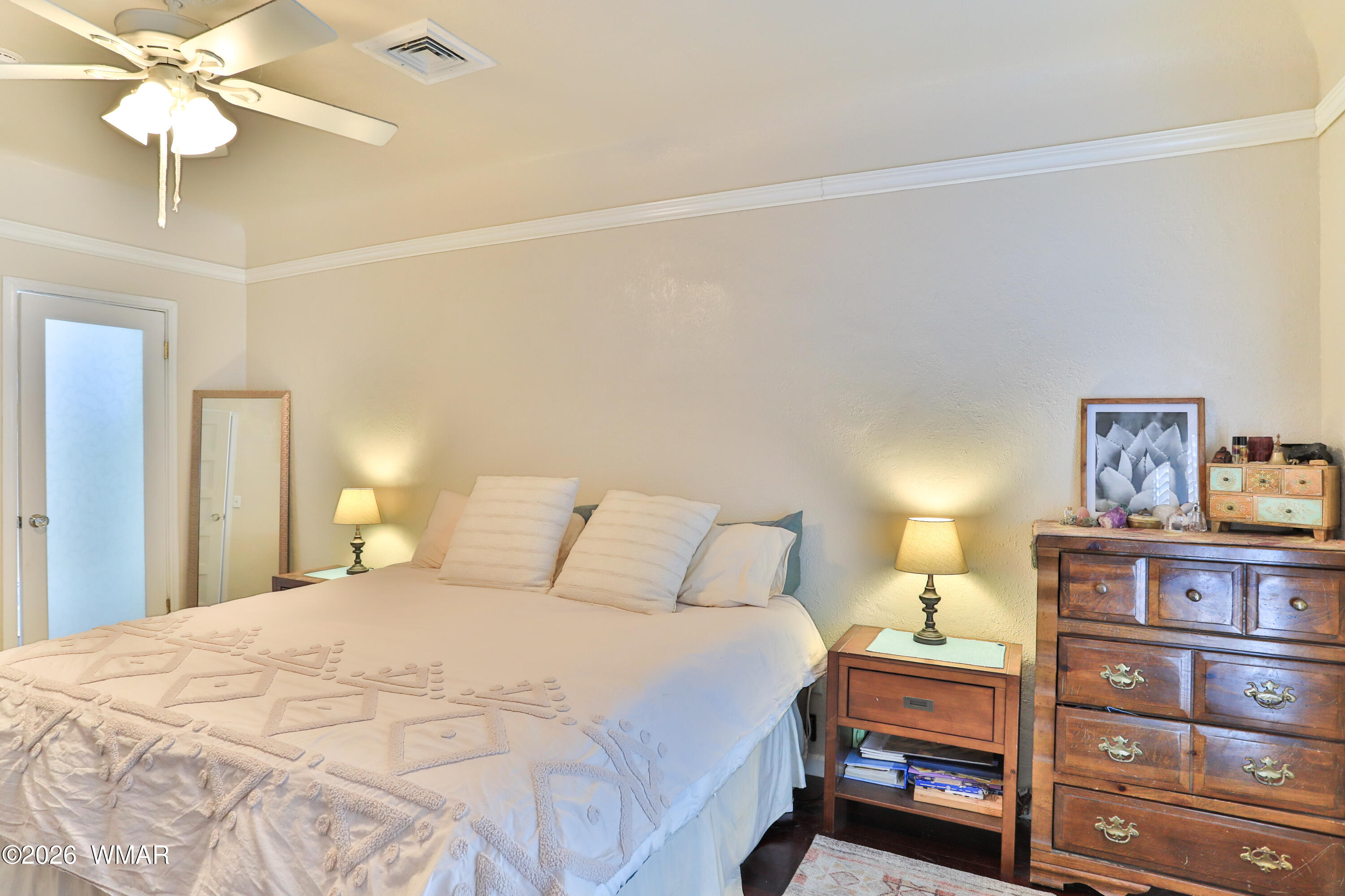 102 Crestview Road Holbrook, AZ 86025 - Photo 21 of 55 a bedroom with a bed and a chandelier