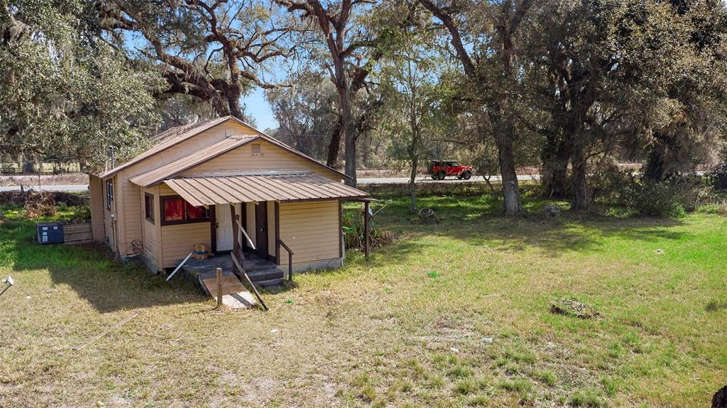 1213 County Road 652 Bushnell, FL 33513 - Photo 1 of 1 a backyard of a house with barbeque oven table and chairs