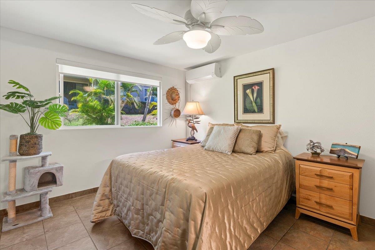 2747 South Kihei Road, Unit E104 Kihei, HI 96753 - Photo 18 of 49 a bedroom with a bed and a chandelier