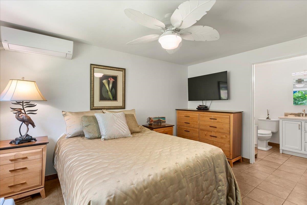 2747 South Kihei Road, Unit E104 Kihei, HI 96753 - Photo 19 of 49 a bedroom with a bed and a flat screen tv