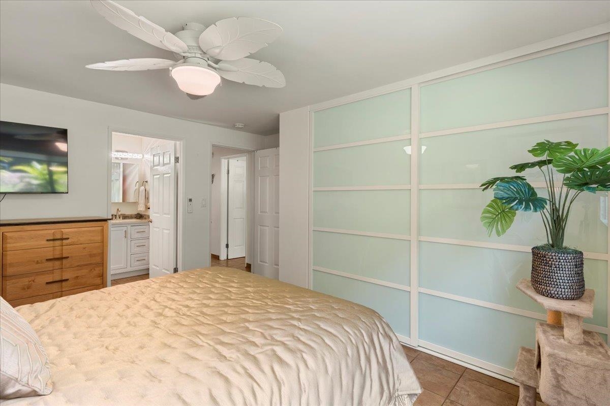 2747 South Kihei Road, Unit E104 Kihei, HI 96753 - Photo 20 of 49 a bedroom with a bed and a potted plant
