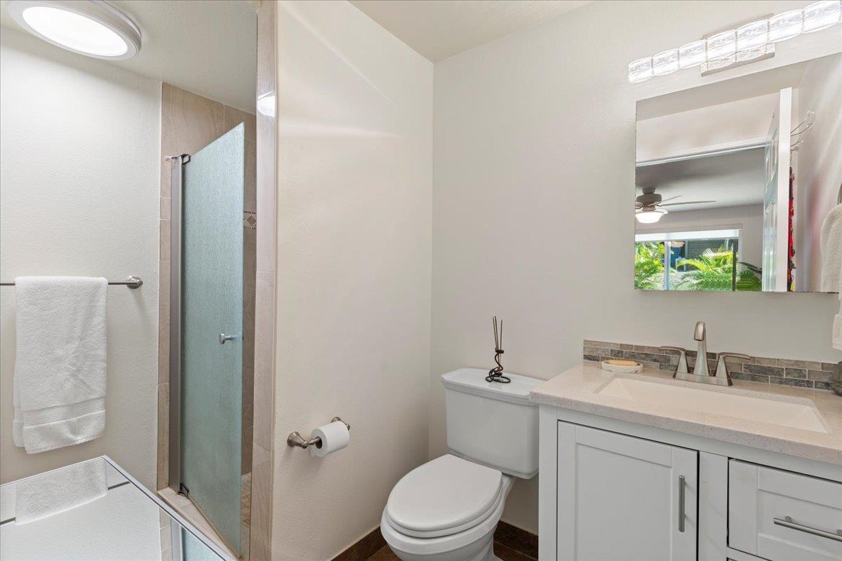 2747 South Kihei Road, Unit E104 Kihei, HI 96753 - Photo 23 of 49 a bathroom with a sink a toilet a shower and a mirror
