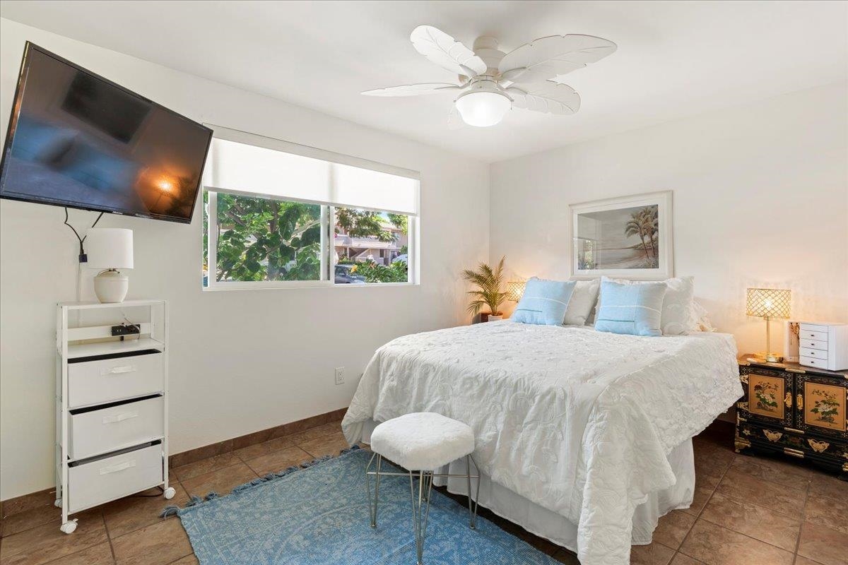 2747 South Kihei Road, Unit E104 Kihei, HI 96753 - Photo 25 of 49 a bedroom with a bed and a flat tv screen on dresser