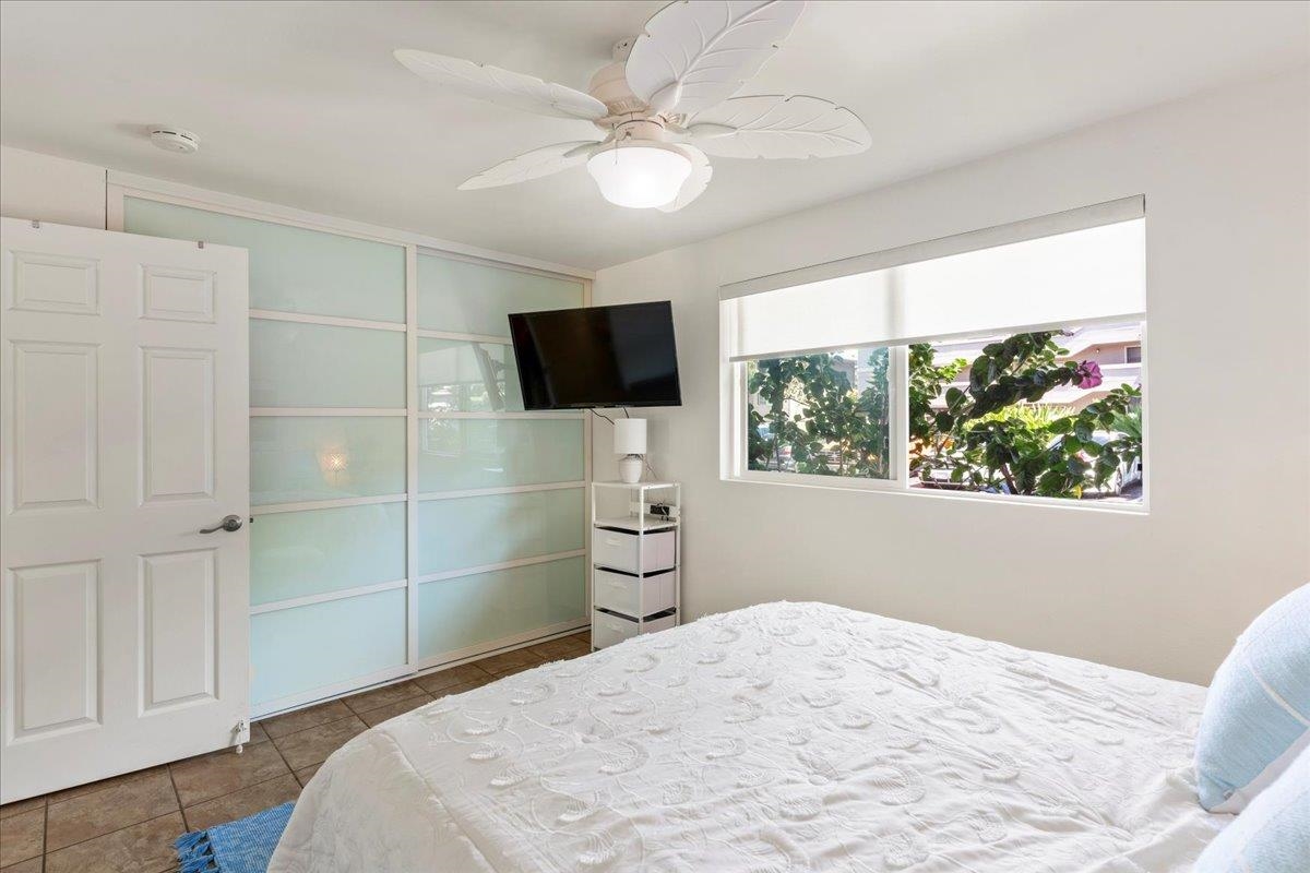 2747 South Kihei Road, Unit E104 Kihei, HI 96753 - Photo 26 of 49 a bedroom with a bed and a flat screen tv