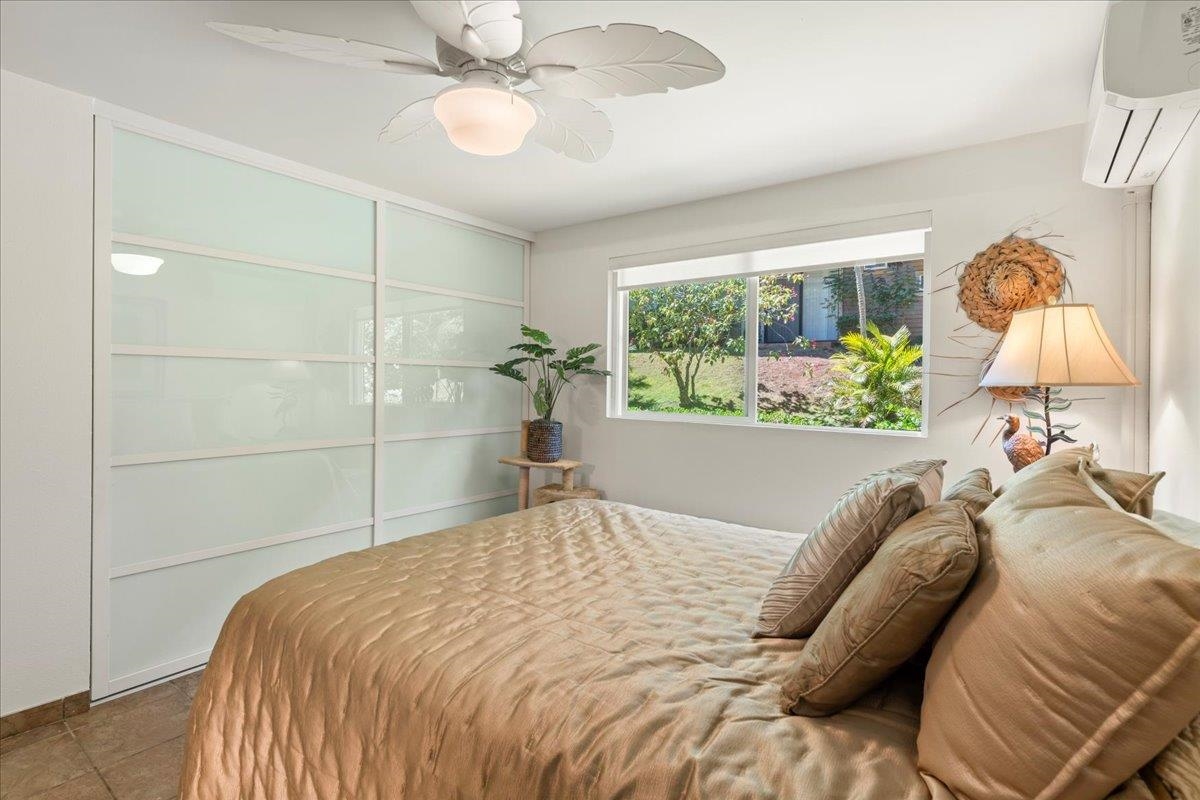 2747 South Kihei Road, Unit E104 Kihei, HI 96753 - Photo 3 of 49 a bed sitting in a bedroom next to a window