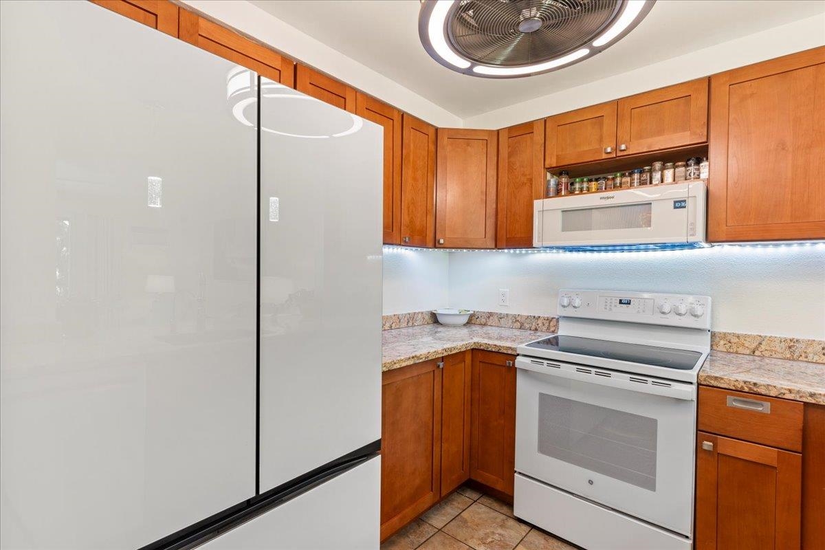 2747 South Kihei Road, Unit E104 Kihei, HI 96753 - Photo 42 of 49 a kitchen with a refrigerator and a sink