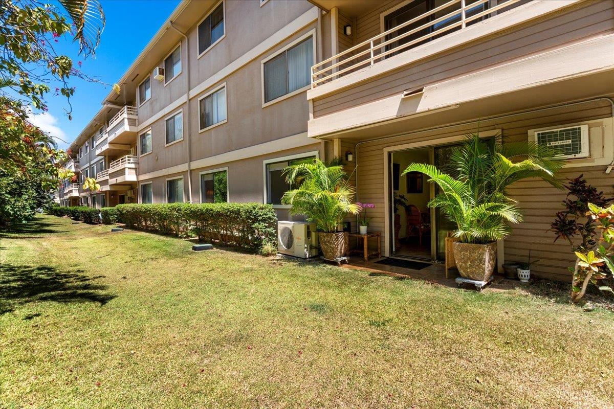 2747 South Kihei Road, Unit E104 Kihei, HI 96753 - Photo 45 of 49 a view of a house with many windows and plants