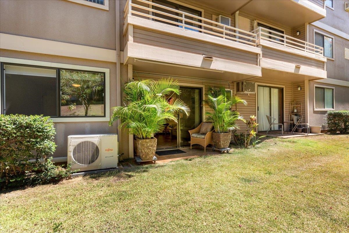 2747 South Kihei Road, Unit E104 Kihei, HI 96753 - Photo 46 of 49 a backyard of a house with table and chairs