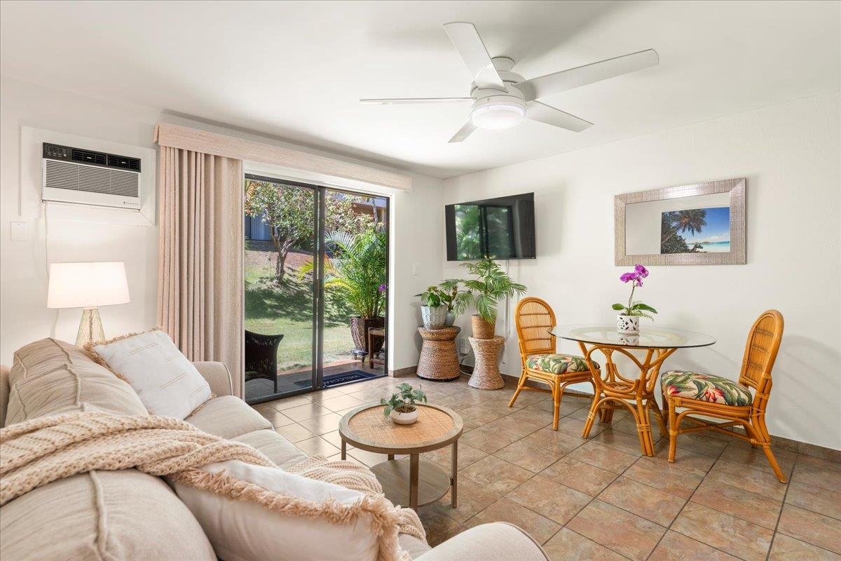 2747 South Kihei Road, Unit E104 Kihei, HI 96753 - Photo 5 of 49 a living room with furniture and a floor to ceiling window