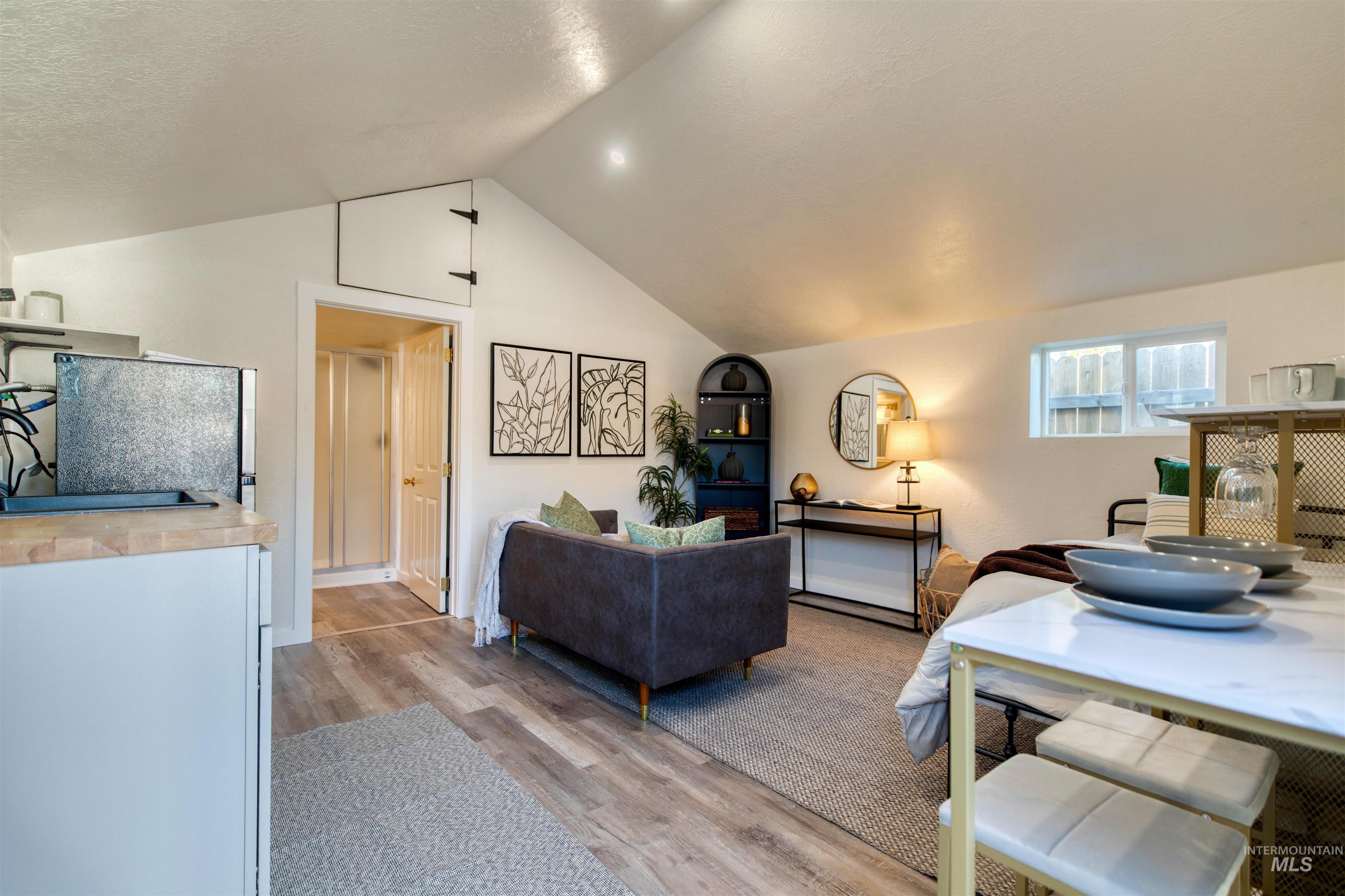 3311 West Hamilton Street Boise, ID 83705 - Photo 23 of 32 Living area with light wood finished floors and lofted ceiling