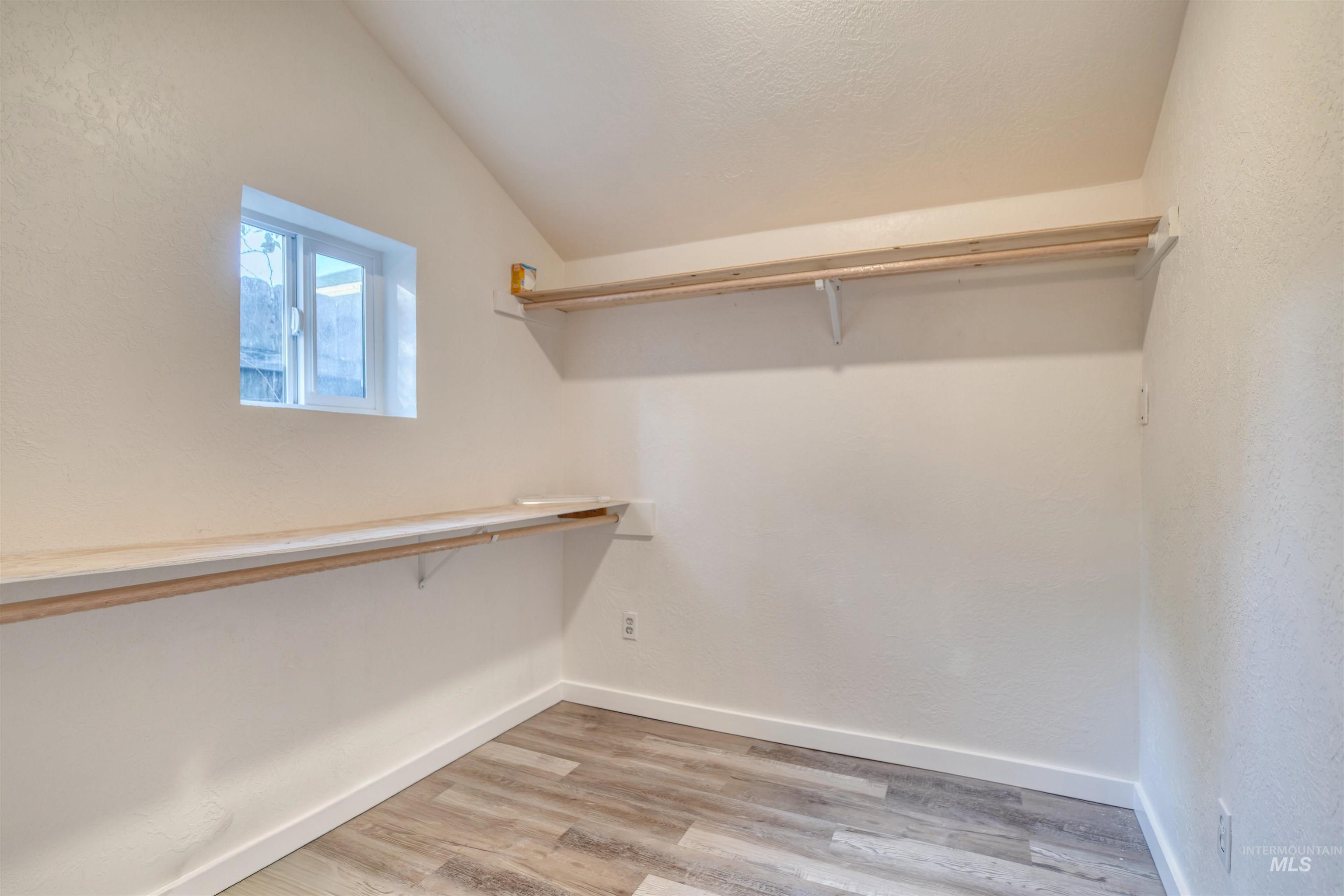 3311 West Hamilton Street Boise, ID 83705 - Photo 30 of 32 Walk in closet with light wood finished floors and lofted ceiling