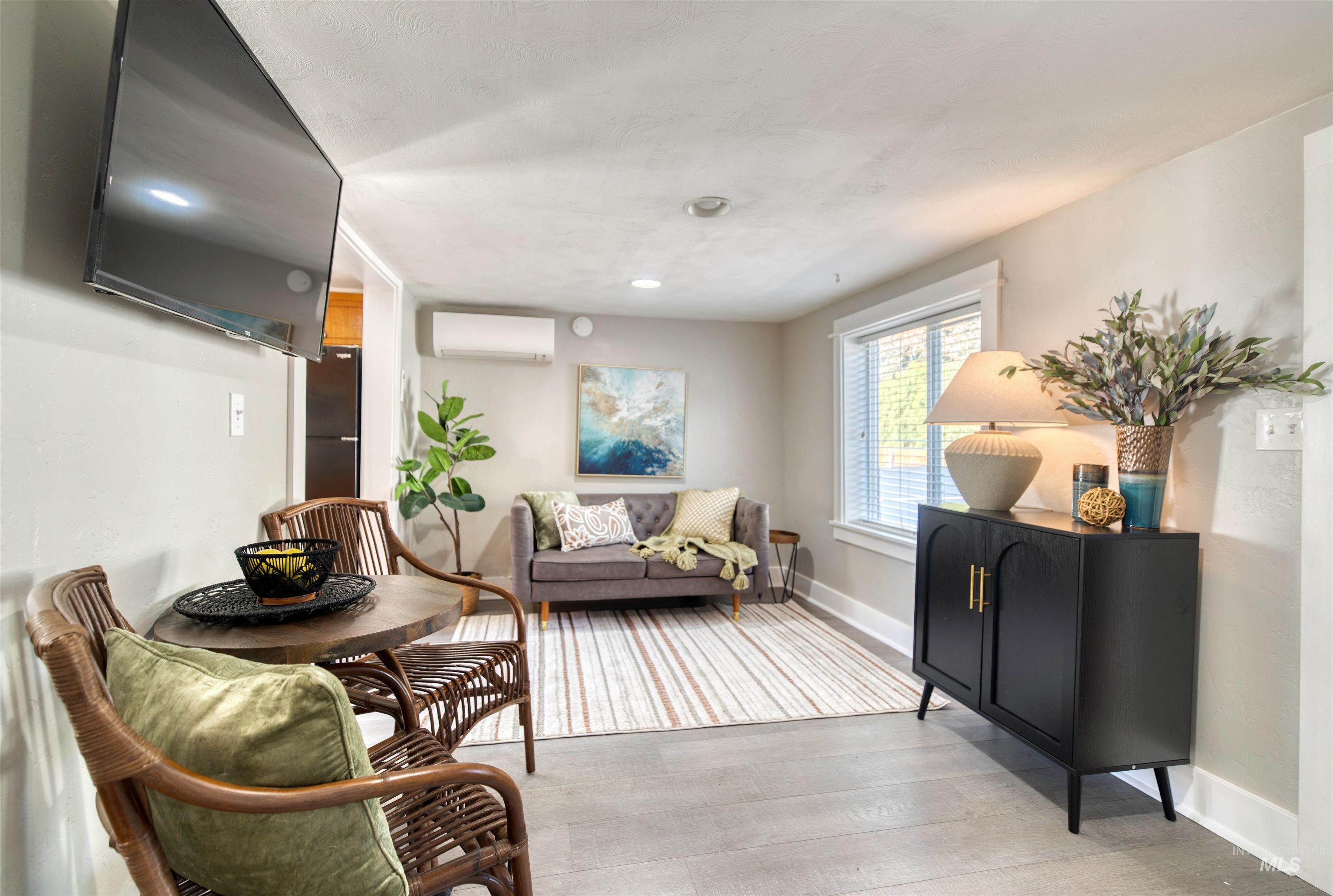 3311 West Hamilton Street Boise, ID 83705 - Photo 7 of 32 Living room featuring light wood-type flooring and a wall unit AC