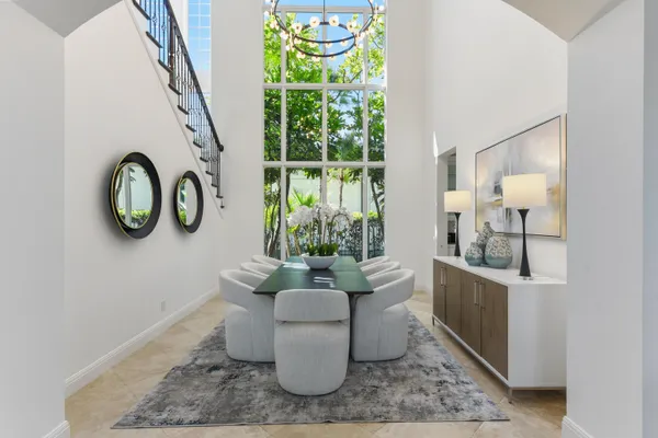 a living room with couches a coffee table and a flat screen tv with wooden floor