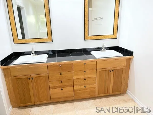 14153 Powers Road Poway, CA 92064 - Photo 8 of 12 a bathroom with a sink and a mirror
