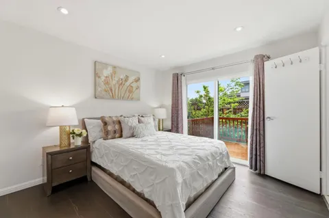 a bedroom with a large bed and a large window