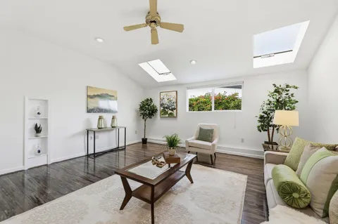a living room with furniture and a potted plant