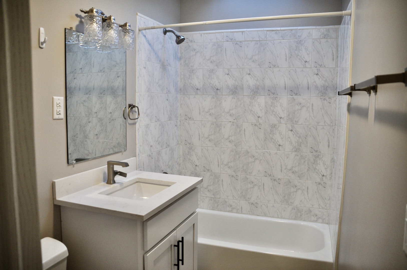 110 West 12th Avenue Naperville, IL 60563 - Photo 13 of 21 a bathroom with a sink and a mirror