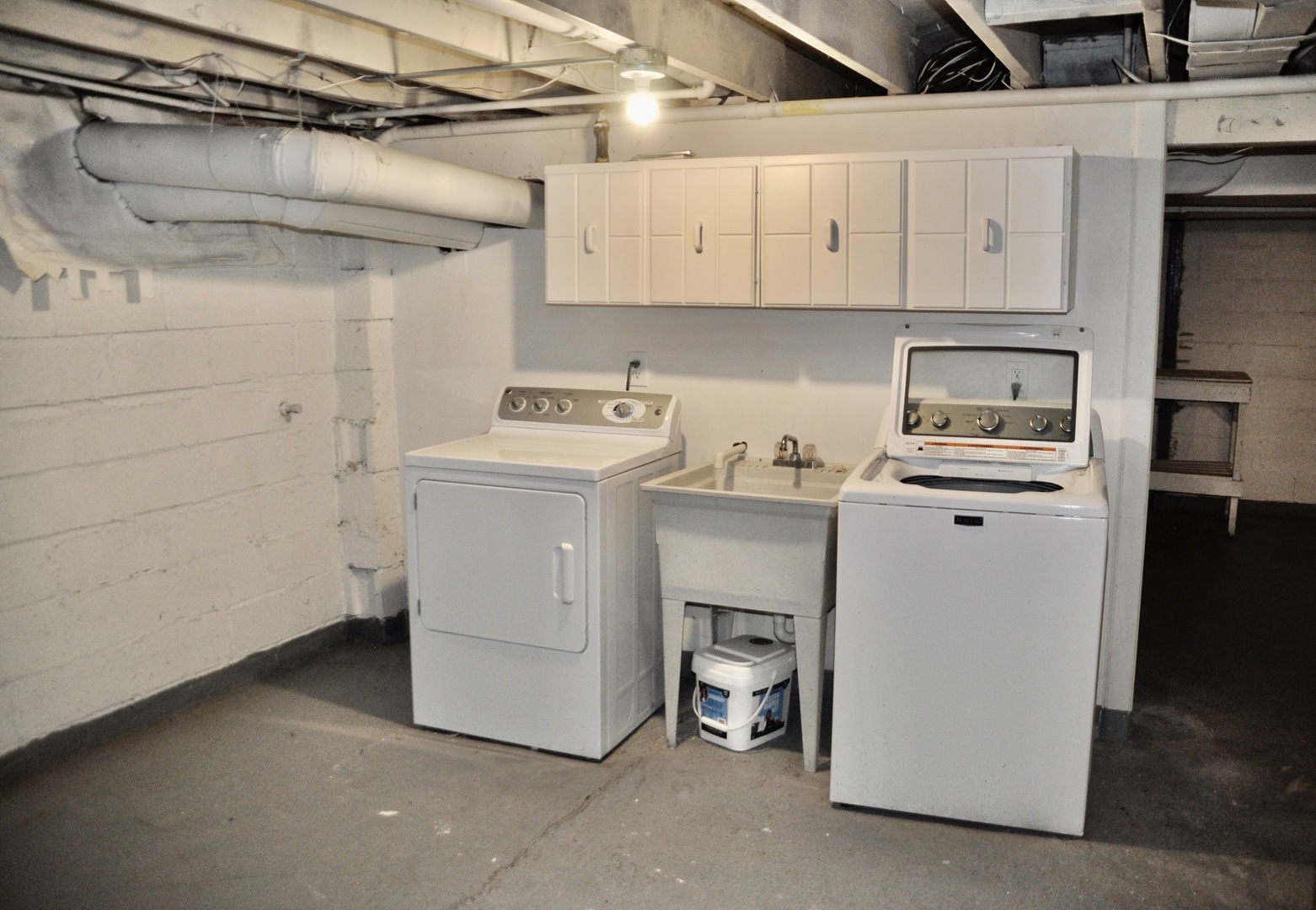 110 West 12th Avenue Naperville, IL 60563 - Photo 21 of 21 a utility room with cabinets washer and dryer