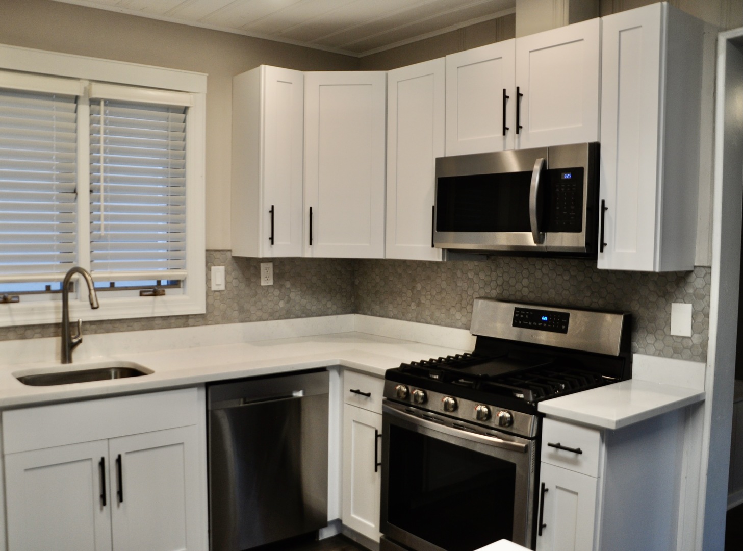110 West 12th Avenue Naperville, IL 60563 - Photo 8 of 21 a kitchen with stainless steel appliances granite countertop white cabinets and a stove top oven