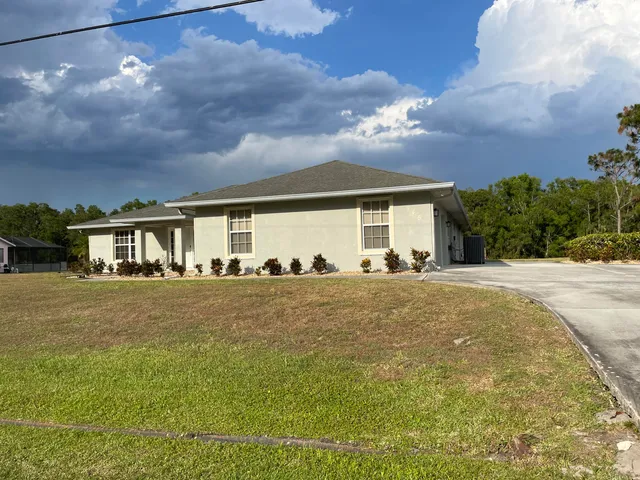 a front view of a house with a garden
