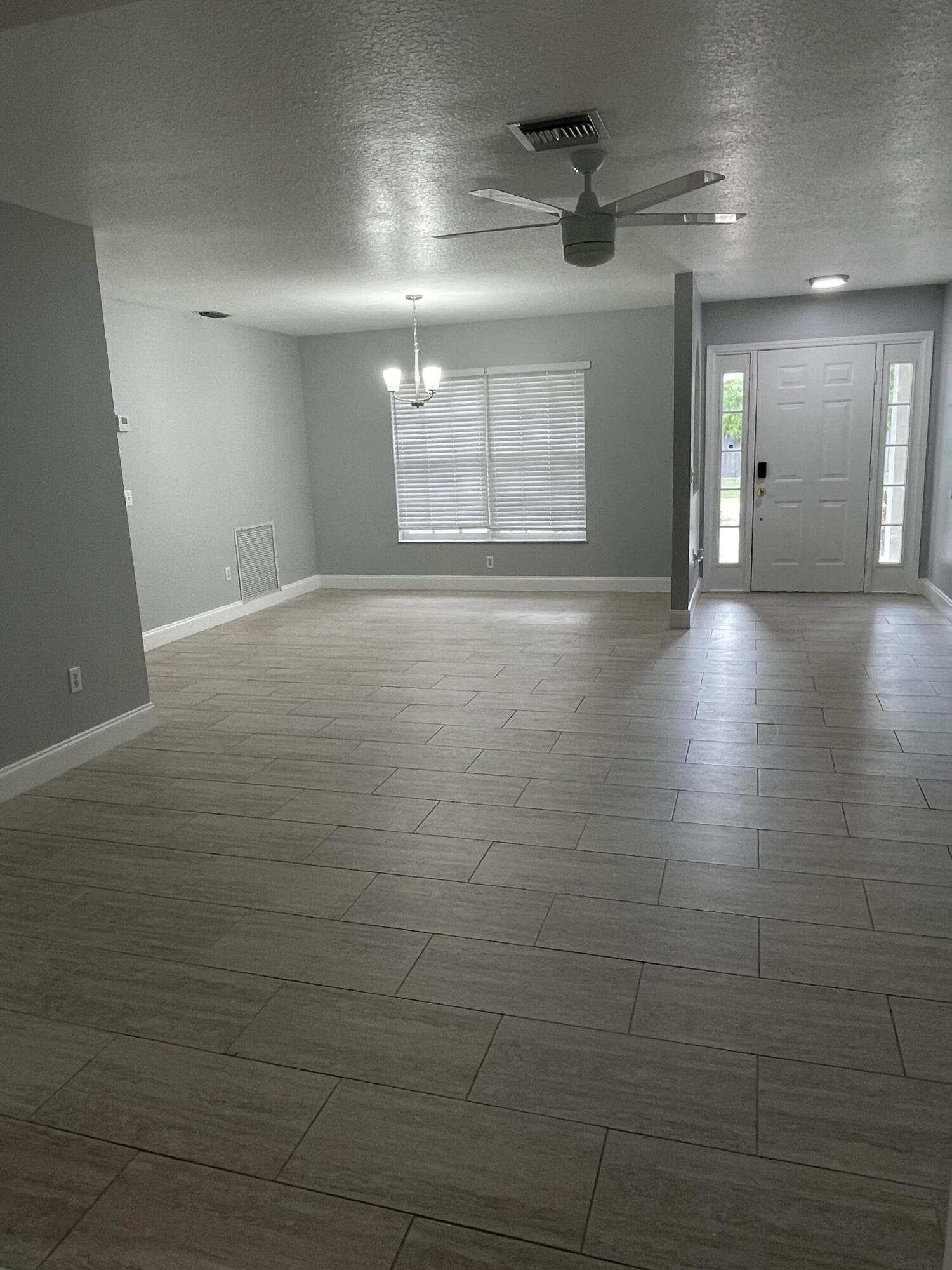 145 Southwest Hawthorne Circle Port St. Lucie, FL 34953 - Photo 12 of 37 a view of a livingroom with a window