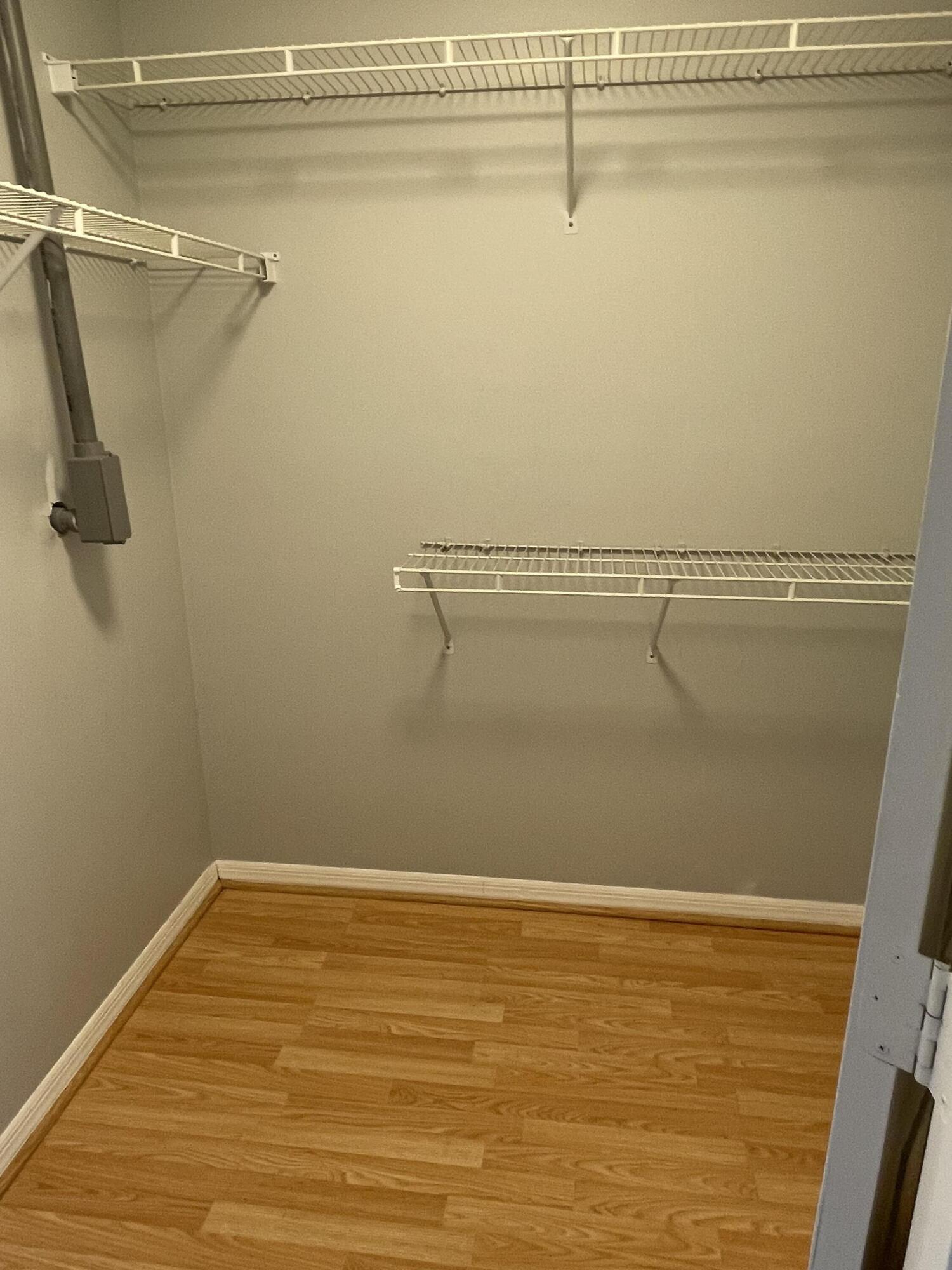 145 Southwest Hawthorne Circle Port St. Lucie, FL 34953 - Photo 15 of 37 a view of a room with racks on the wall