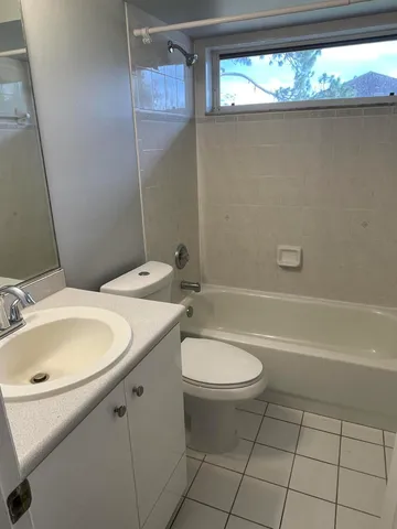 a bathroom with a sink a toilet and tub