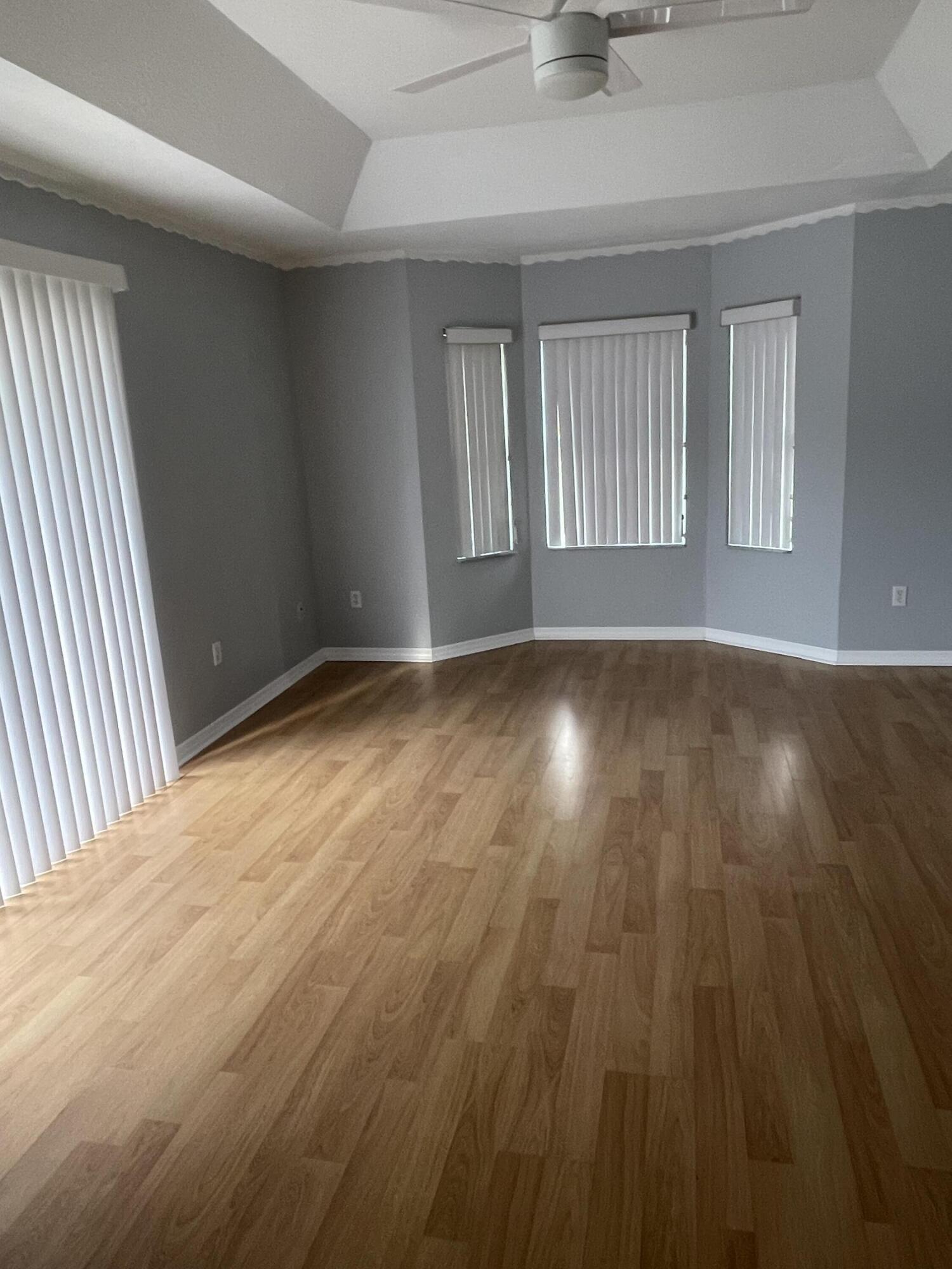 145 Southwest Hawthorne Circle Port St. Lucie, FL 34953 - Photo 25 of 37 a view of an empty room with wooden floor