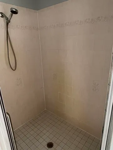 a bathroom with a bathtub sink and mirror