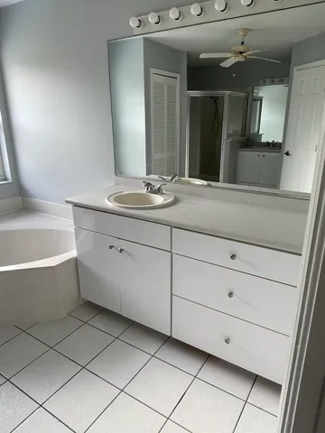 a bathroom with a sink a bathtub and window
