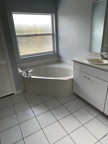 a bathroom with a bathtub and window