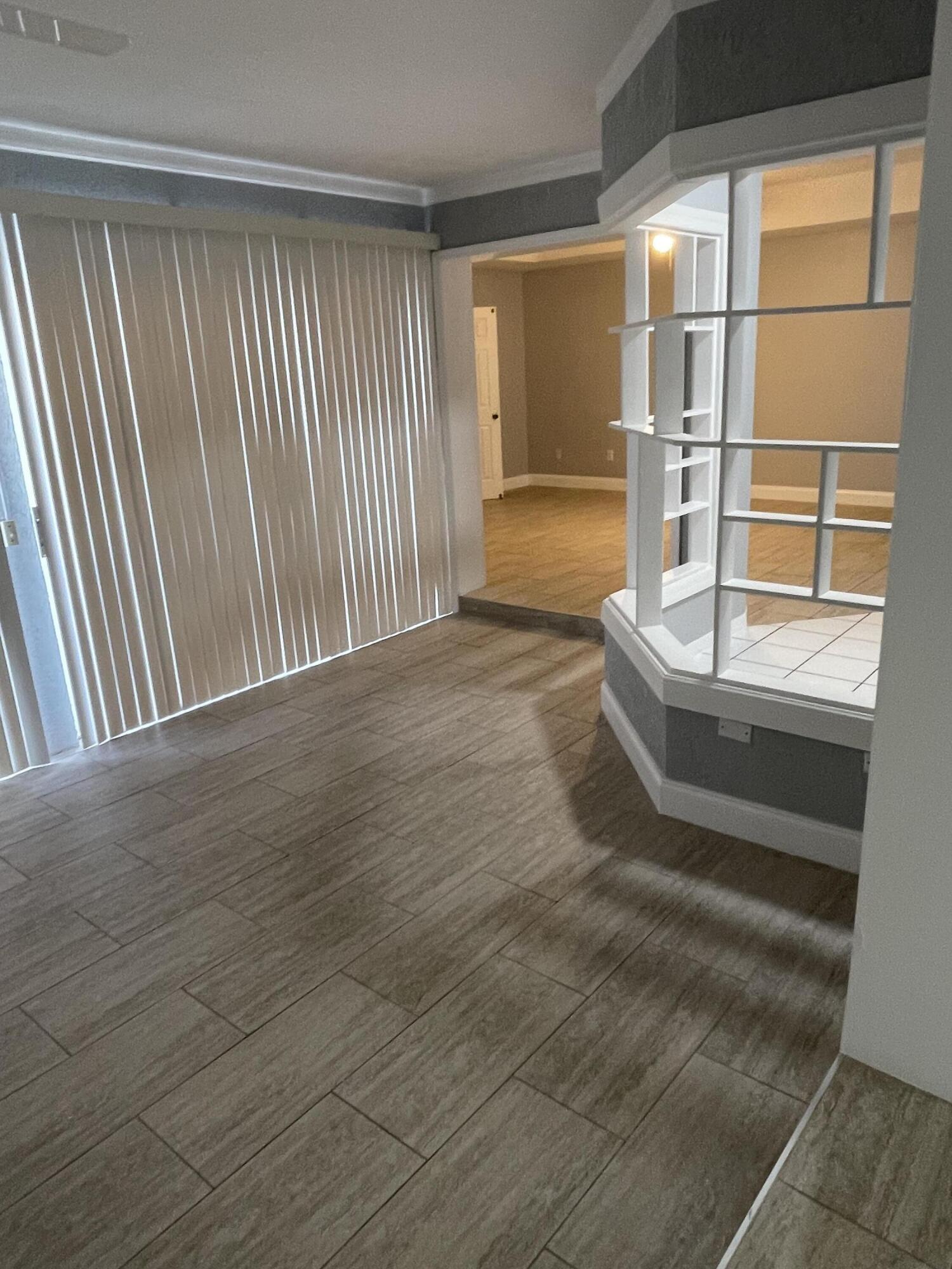 145 Southwest Hawthorne Circle Port St. Lucie, FL 34953 - Photo 31 of 37 a view of empty room with wooden floor and fan