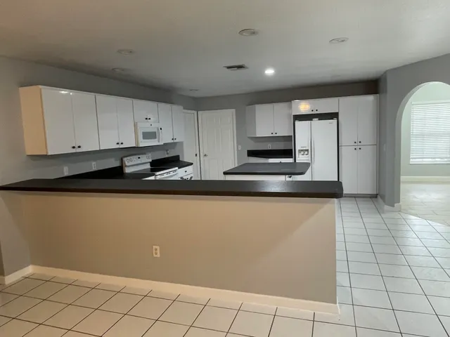 a kitchen with stainless steel appliances granite countertop a refrigerator sink and cabinets