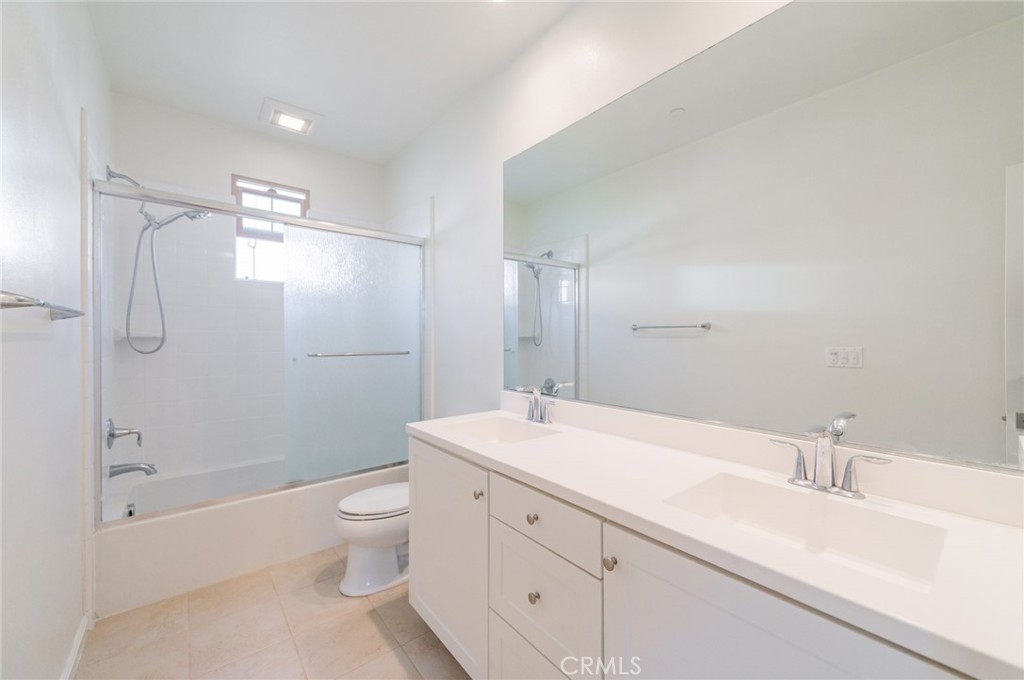 103 Tidal Irvine, CA 92620 - Photo 17 of 25 a spacious bathroom with a double vanity sink toilet mirror and shower