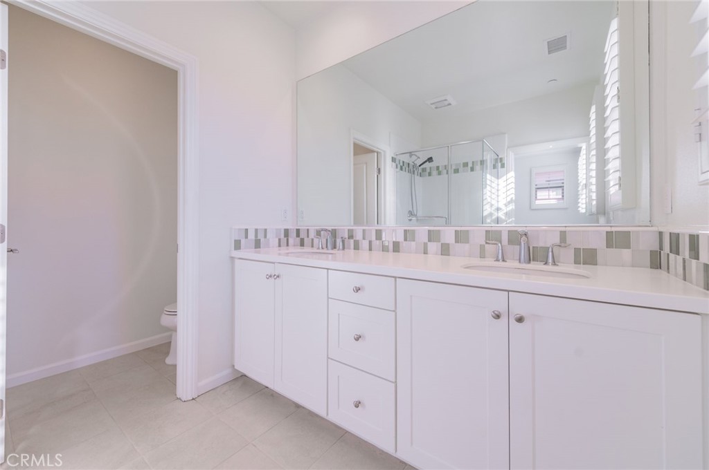 103 Tidal Irvine, CA 92620 - Photo 22 of 25 a bathroom with a sink and a mirror