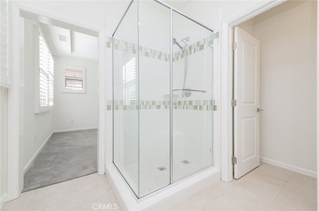 103 Tidal Irvine, CA 92620 - Photo 23 of 25 a view of a bathroom with a glass shower door