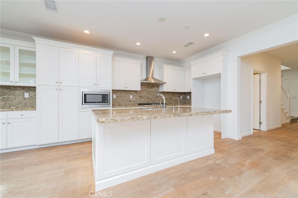 103 Tidal Irvine, CA 92620 - Photo 8 of 25 a kitchen with stainless steel appliances granite countertop a stove a sink and a refrigerator