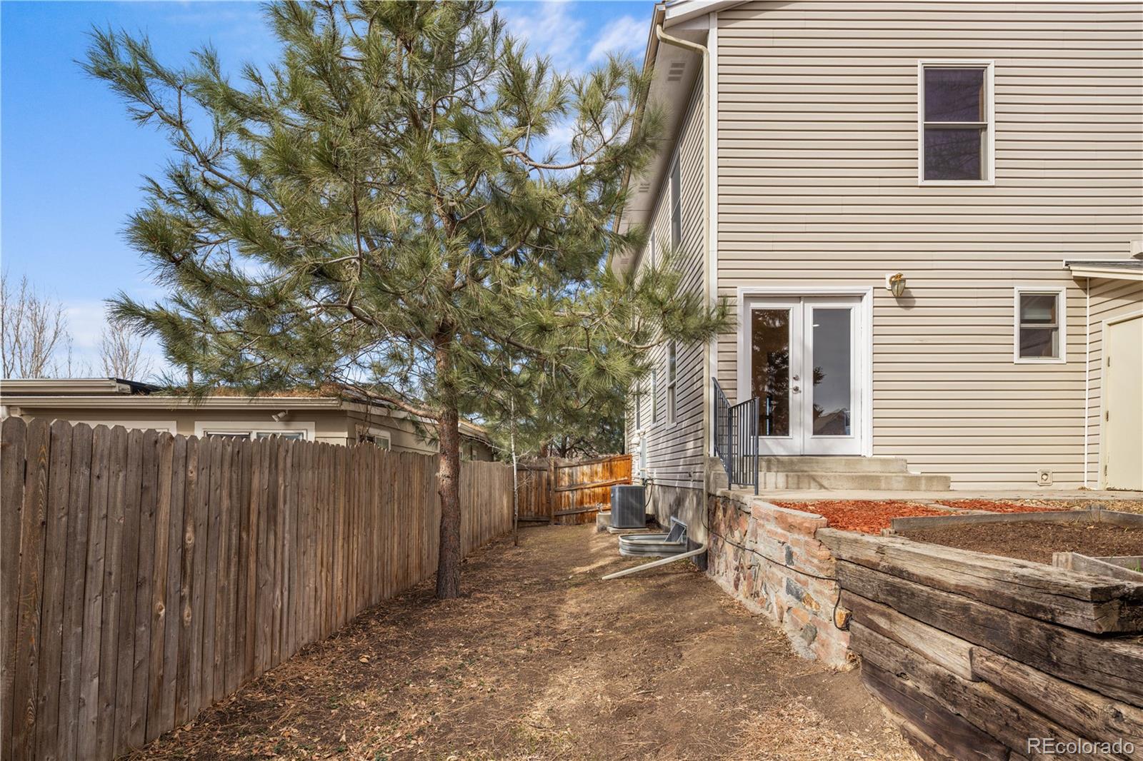 380 County Road Louisville, CO 80027 - Photo 34 of 42 a view of a backyard with wooden fence and large trees