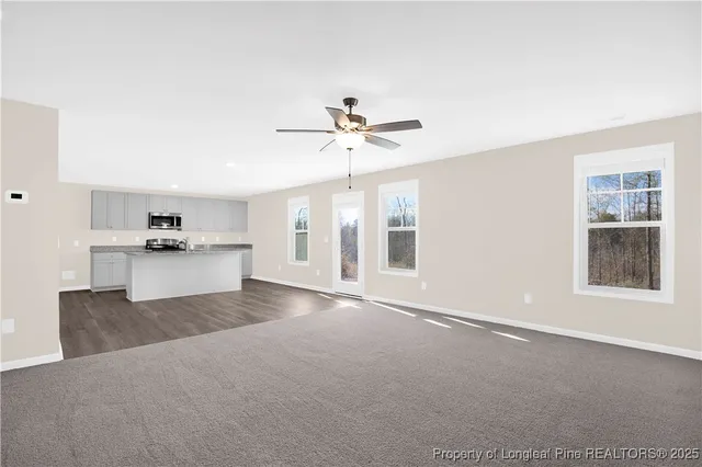 a view of an empty room with a kitchen
