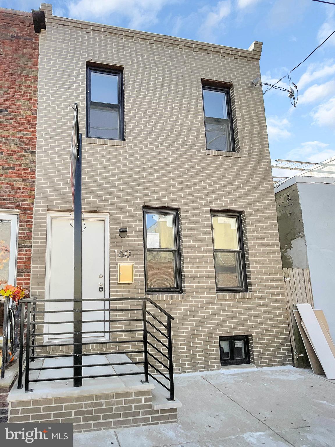 a view of a brick house with many windows