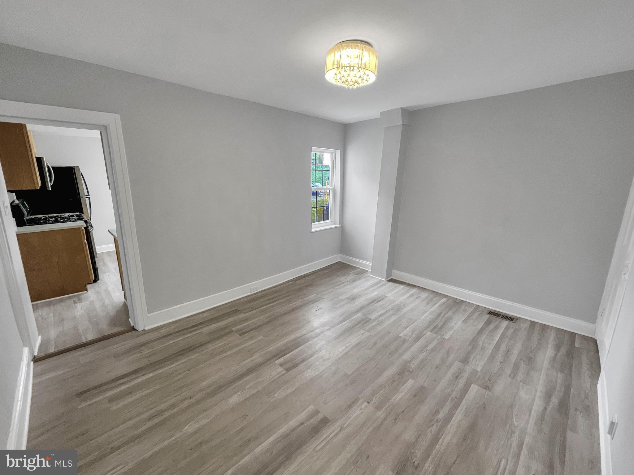 160 McClellan Street Philadelphia, PA 19148 - Photo 13 of 29 a view of an empty room with a fireplace and wooden floor