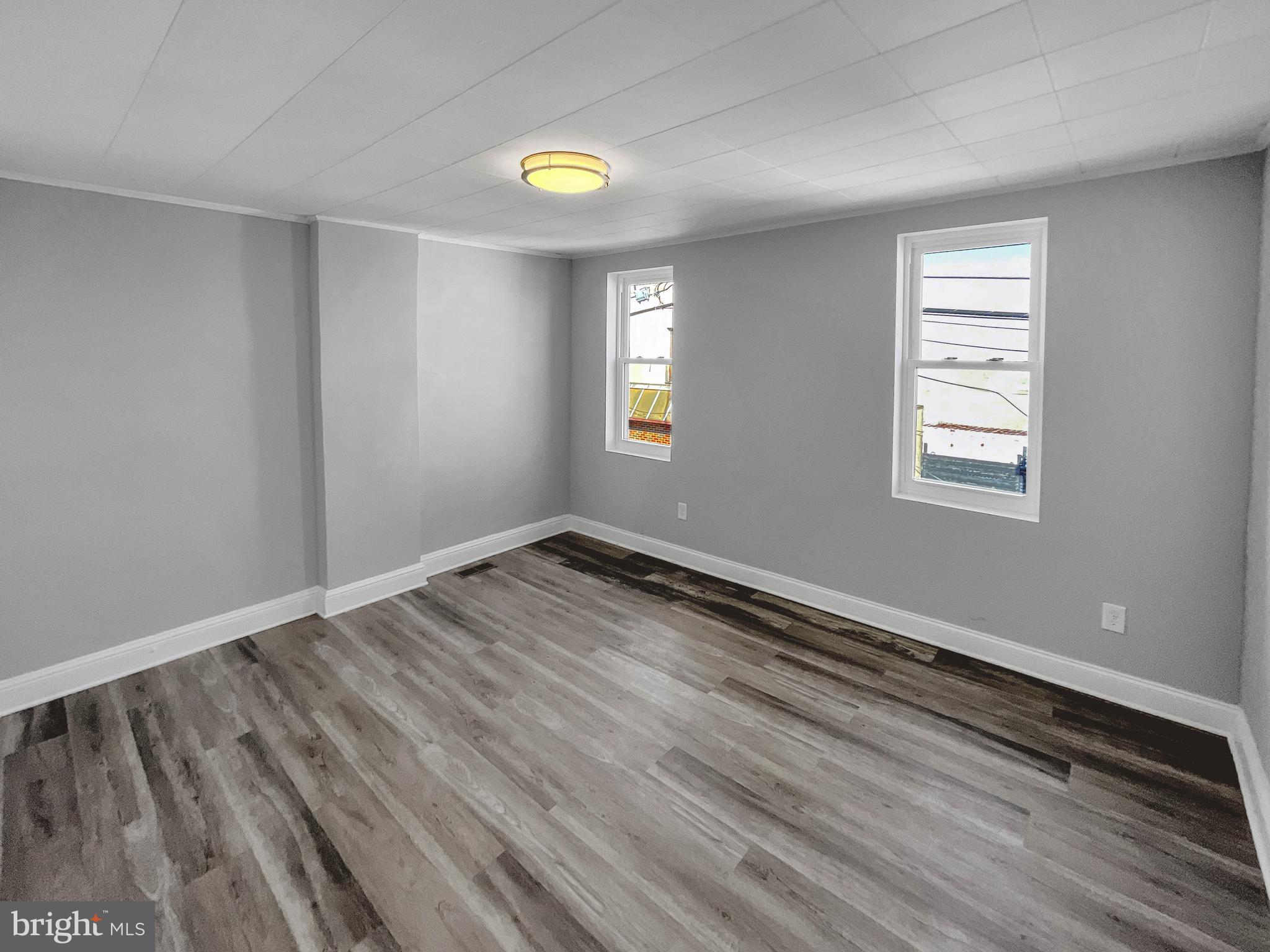 160 McClellan Street Philadelphia, PA 19148 - Photo 16 of 29 an empty room with window and wooden floor