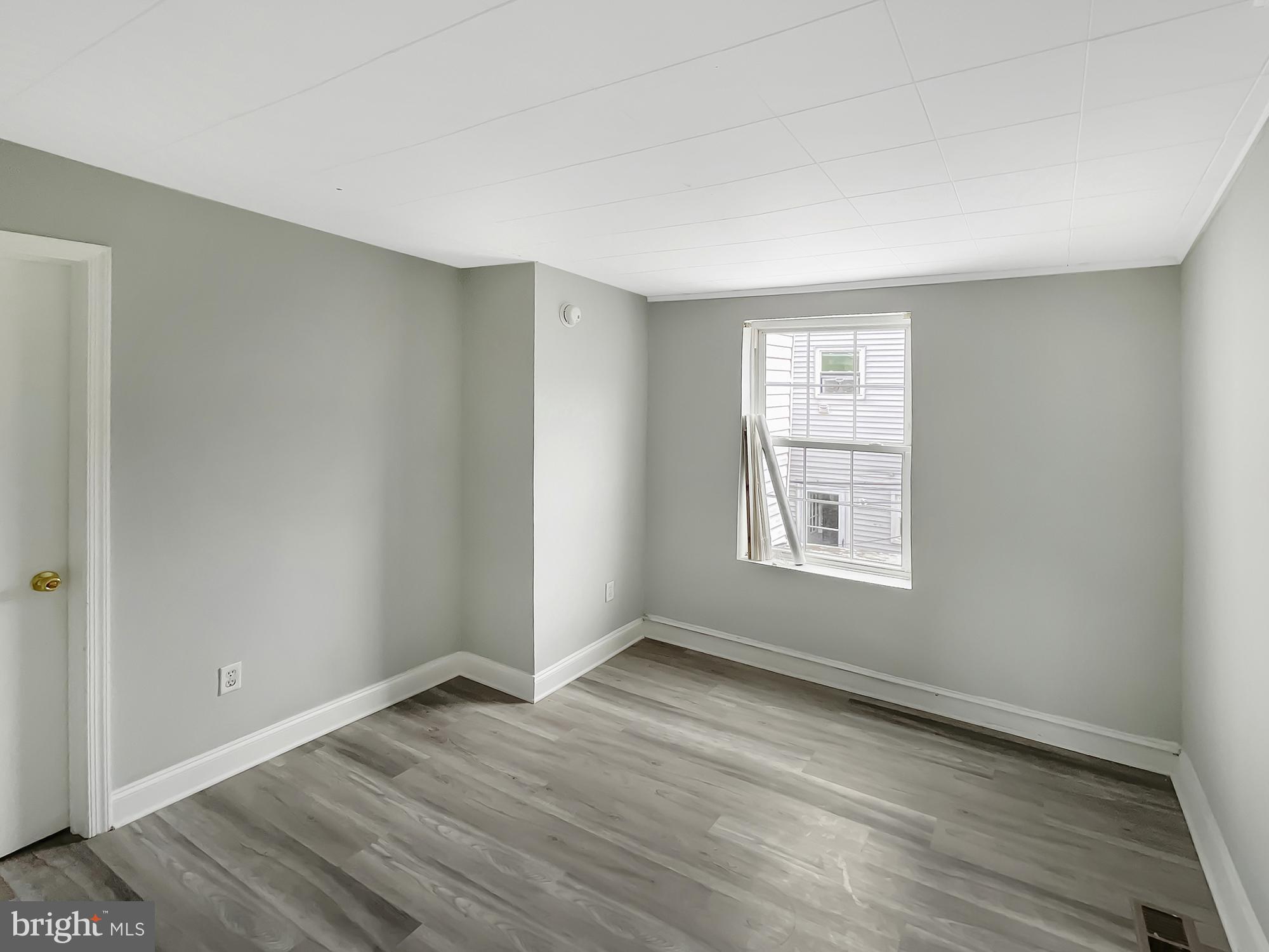 160 McClellan Street Philadelphia, PA 19148 - Photo 19 of 29 an empty room with wooden floor and windows